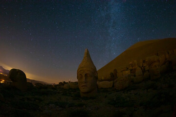 Ancient statues on the Nemrut mountain on the beautiful. Milky way galaxy. Unesco heritage. Nemrut, Turkey. Night landscape.