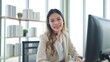 © M Stocker - Smilling face of young Asian woman customer support phone operator with headset working in call center looking at camera