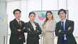 © M Stocker - A group of young professional asian business people wearing suit standing looking at camera and arms crossed in office