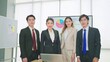 © M Stocker - A group of young professional asian business people wearing suit standing and looking at camera