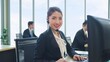 © M Stocker - Smilling face of young Asian woman customer support phone operator with headset working in call center