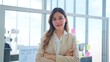 © M Stocker - Young professional asian businesswoman with smilling face standing and crossing arms and looking at the camera