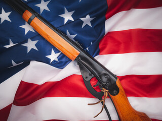 Wall Mural - Top view of a shotgun on the American flag background