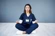 © Rene La/peopleimages.com - Nurse, calm or sitting meditation on hospital mockup, clinic mock up or wall for mental health, peace or chakra wellness. Doctor, healthcare or meditating woman for zen mindset, relax energy or yoga