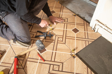 Wall Mural - Laying floor ceramic tile. Renovating the floor