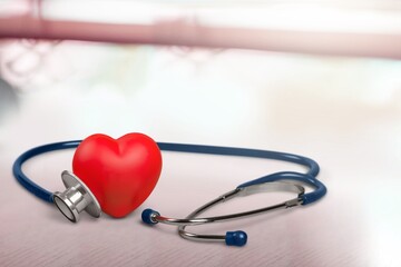 Wall Mural - Red heart with medical stethoscope on desk