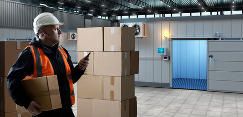 Wall Mural - Man cold storage contractor. Guy with phone and box. Refrigeration technologies. Worker in hangar with cold rooms. Man carries box to refrigerator. Cold rooms with open door behind storekeeper