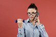 © primipil - Successful young modern businesswoman in blue shirt warming up with dumbbells at office while working and speaking mobile phone, Business, work, woman and sport fitness workout exercise concept