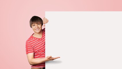 Happy young smart man posing on background