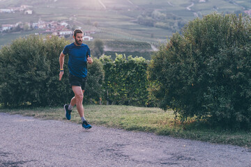 Wall Mural - man running in the countryside at the sunset