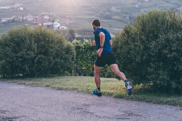 Wall Mural - man running in the countryside at the sunset