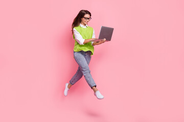 Canvas Print - Full length photo of satisfied girl straight hair dressed green vest typing on laptop hurry at work isolated on pink color background