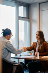 Wall Mural - Young businesswoman greets her male colleague in office.