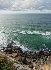 Wall Mural - rocky coastline, ocean and cloudy sky above it. beautiful nature background.
