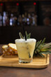 pineapple caipirinha in a glass on a wooden surface