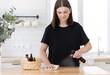 Young woman cleans the kitchen with eco products.
