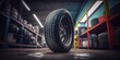 © Infinite Shoreline - A tyre at the repair shop, service garage background, car fixing - generative ai