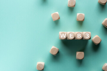 Poster - There is wood cubes with the word Web3. It is an eye-catching image.