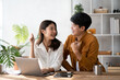 © PaeGAG - Photo of cheerful loving young couple using laptop computer and analyzing their finances with documents. Familay investment concept.