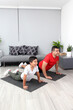 Overweight Latino dad and son exercise at home to lose weight and be healthy to avoid diseases such as diabetes or hypertension