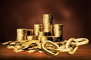 Wall Mural - Stack gold coin and chains on wooden desk