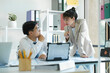 © ijeab - Businesspeople are working by discuss and analyses their project by using laptop and calculator.