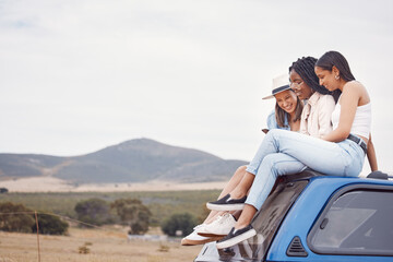 Canvas Print - Road trip, car and happy friends with phone, social media update and countryside adventure on sky mockup space. Youth, gen z and diversity women on 5g smartphone and roof for travel journey together