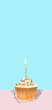 Colorful cupcake with single birthday candle on a blue background with empty space for text