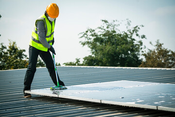 Wall Mural - Maintenance technician using high pressure water to clean the solar panels that are dirty with dust to improve the efficiency of solar energy storage.