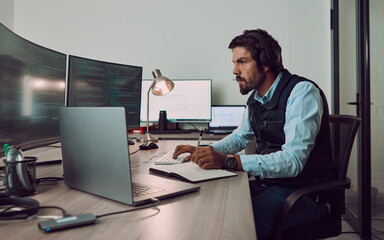 Poster - Headphones, programmer and man on computer with book, coding or programming while writing notes at night. Information technology, notebook and male working on software while streaming music or radio.
