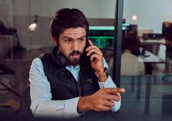Poster - Programmer, phone call and man talking in office, chatting and speaking to contact at night. Information technology, pointing and thinking male employee or coder with mobile smartphone for networking
