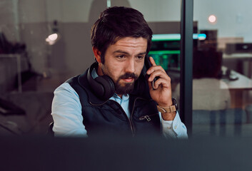 Poster - Programmer, phone call and man talking, thinking or chatting and speaking to contact at night office. Information technology, idea and male coder with mobile for networking while looking at computer.