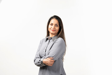 Happy successful Indian woman standing in casual outfit, confident, smiling pleased at camera