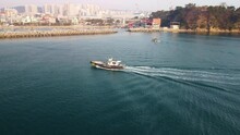 Drone Aerial View Of A Fishing Boat Returning To The Ilsan Port Near Daewangam, Ulsan District, South Korea.