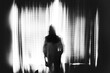 © Cavan Images - Spooky image of ghost girl standing in window in eery light