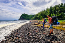 Backpackers Stoping To Take In The Pacific Ocean In The Pololu Valley