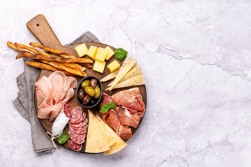 Wall Mural - Antipasto board with various meat and cheese snacks