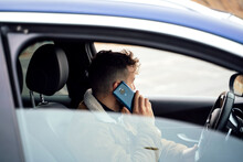 Person using his smartphone in his car