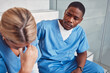 © Courtney/peopleimages.com - Doctors, nurses or healthcare team with stress and depression talking about empathy. Black man support crying woman in hospital with mental health, depression and anxiety for crisis fail or mistake