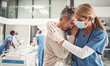 © Courtney/peopleimages.com - Doctor, hug and sad senior woman in hospital for support, comfort and empathy for surgery of husband. Medic, face mask and embrace wife of patient with covid 19 emergency in clinic with solidarity