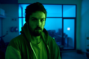 Leinwandbilder - Man, portrait and criminal in dark neon garage with cybersecurity vision, software programming thinking or phishing. Hacker, face and night clothes for secret virus ideas of fraud scam or innovation