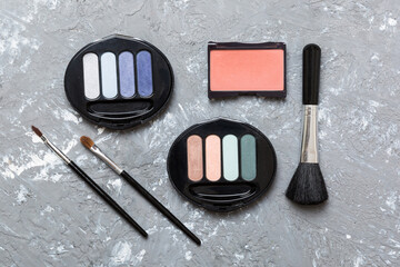 Wall Mural - Professional makeup tools. Top view. Flat lay. Beauty, decorative cosmetics. Makeup brushes set and color eyeshadow palette on table background. Minimalistic style