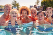 © Monkey Business - Portrait Of Multi-Cultural Group Of Senior Friends Relaxing In Outdoor Pool On Summer Vacation