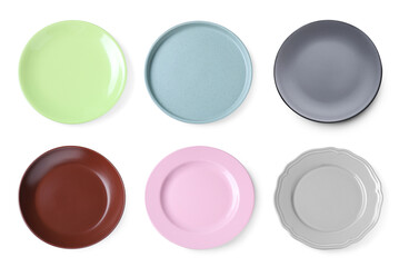 Set of different ceramic plates on white background, top view