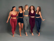 © gpointstudio - Full length of group of five young women in sports clothes having fun in studio shot