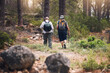 © Azee J/peopleimages.com - Hiking, fitness and people walking in forest for adventure, freedom and sports on mountain trail. Travel, training and back of hikers for exercise wellness, trekking and cardio workout in nature