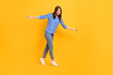 Sticker - Full size profile photo of pretty satisfied girl carefully walk balancing empty space rope isolated on yellow color background