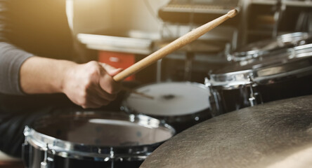 Wall Mural - Drummer playing on drums and bronze cymbal plates with drumsticks live music. Musician during percussion instrumental perfomance