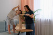© yavdat - Mother and her son assembling furniture together at home