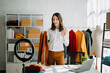 © Nuttapong punna - Fashion blogger concept, Young Asian women selling clothes on video streaming.Startup small business SME, using smartphone or tablet taking receive and checking.
